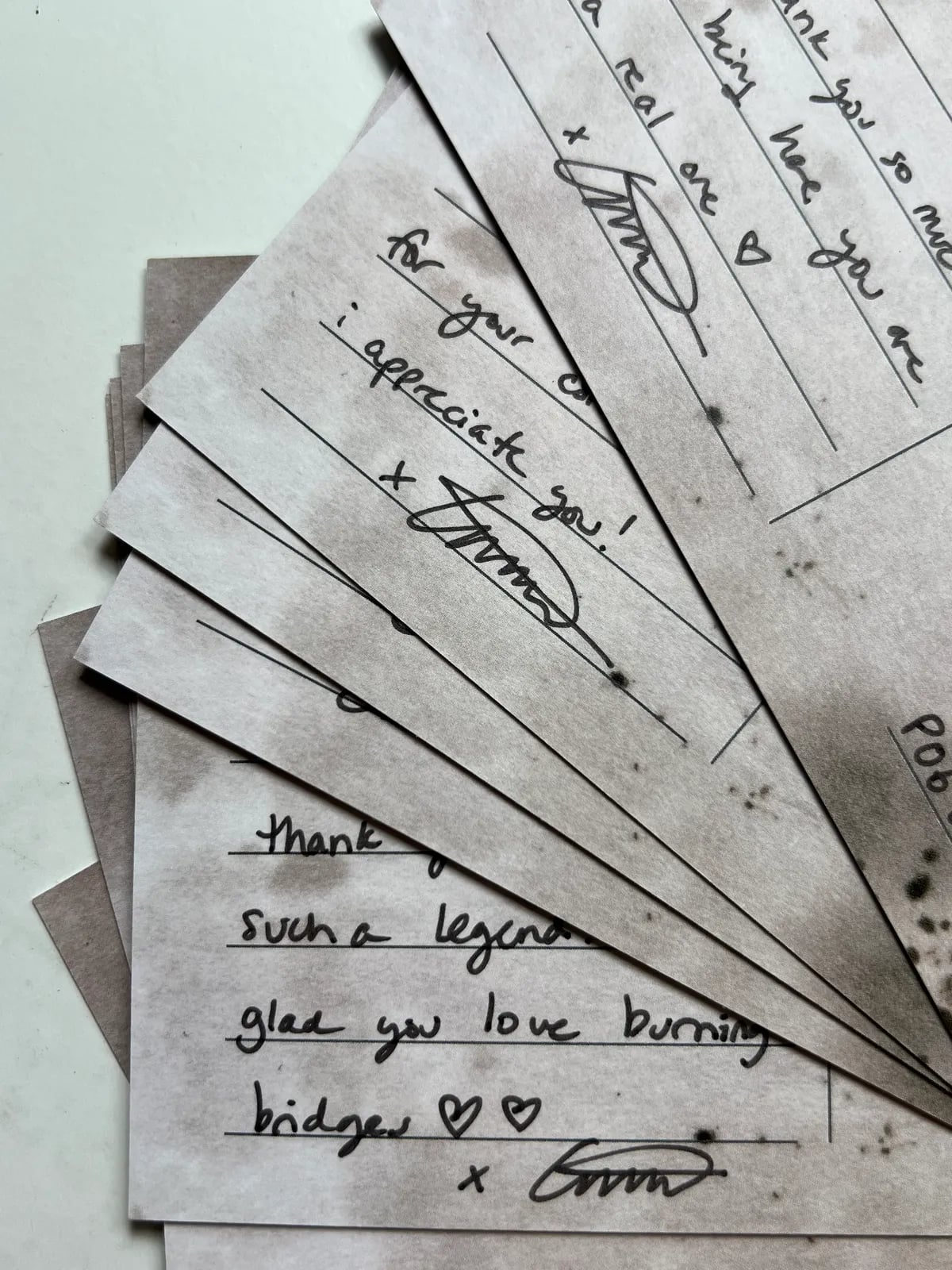 Hand-written EMMMA postcards fanned out
